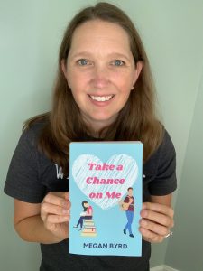 Me holding a copy of my book Take a Chance on Me